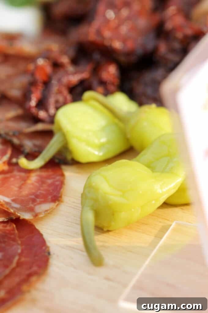 Assortment of cured meats and cheeses, perfectly complementing the Mezzetta products on the platter