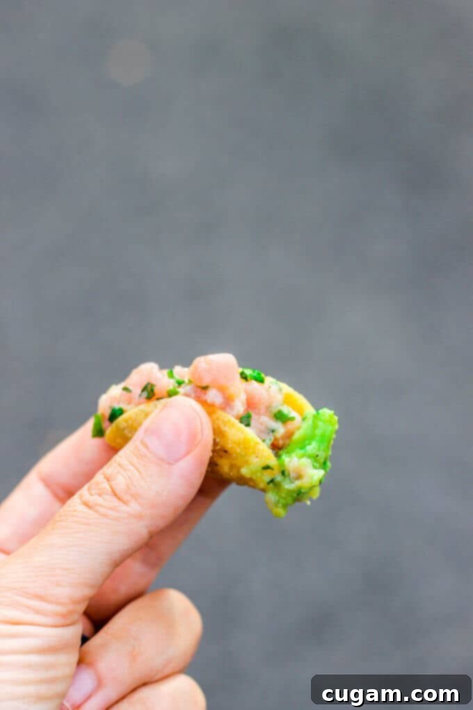 A close-up of the Spicy Tuna Taco, showcasing the vibrant ingredients and the tantalizing peperoncini guacamole