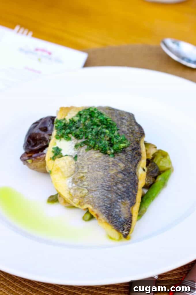 Exquisite Pan Seared Bronzino, adorned with a vibrant Mezzetta Peperoncini & Caper Gremolata, served with roasted Brussels Sprouts