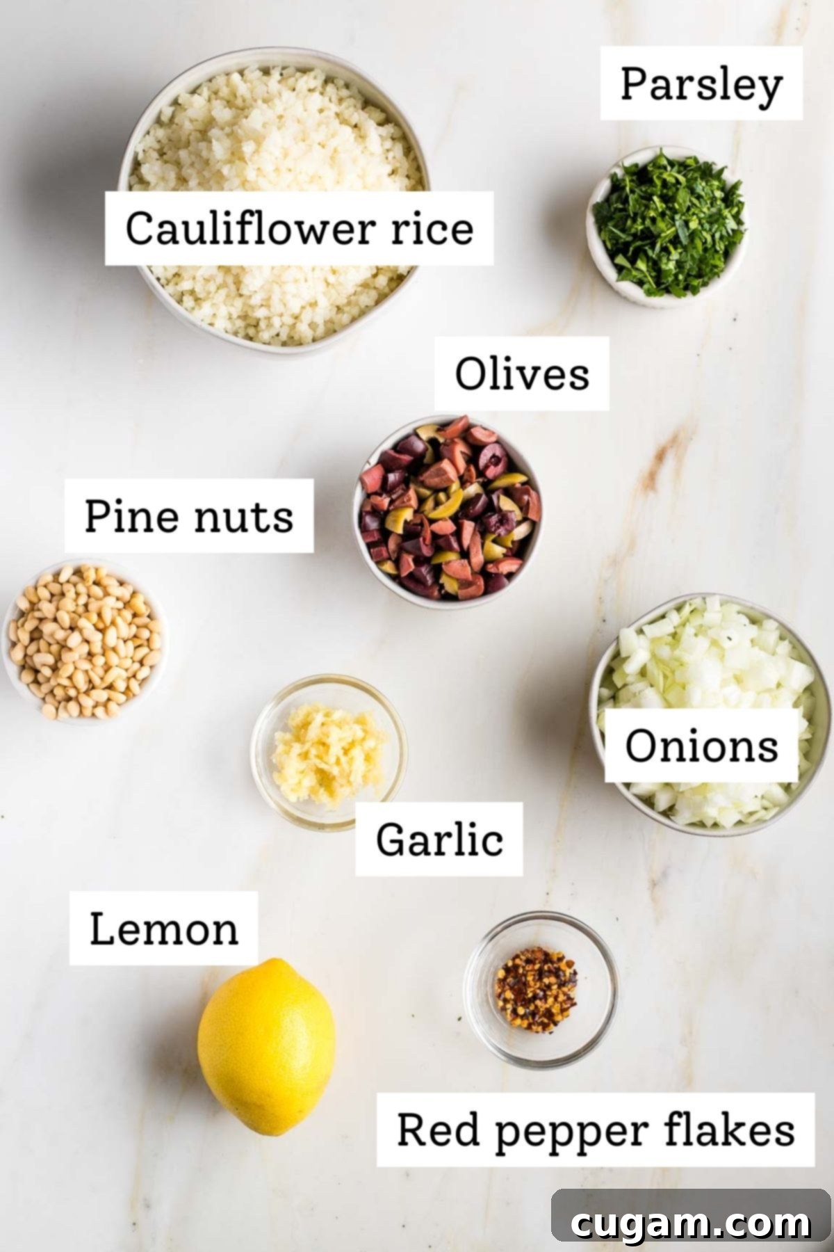 Vibrant Mediterranean Cauliflower Rice 3 Labeled ingredients: cauliflower rice, fresh parsley, olives, pine nuts, onions, garlic, lemon, red pepper flakes.