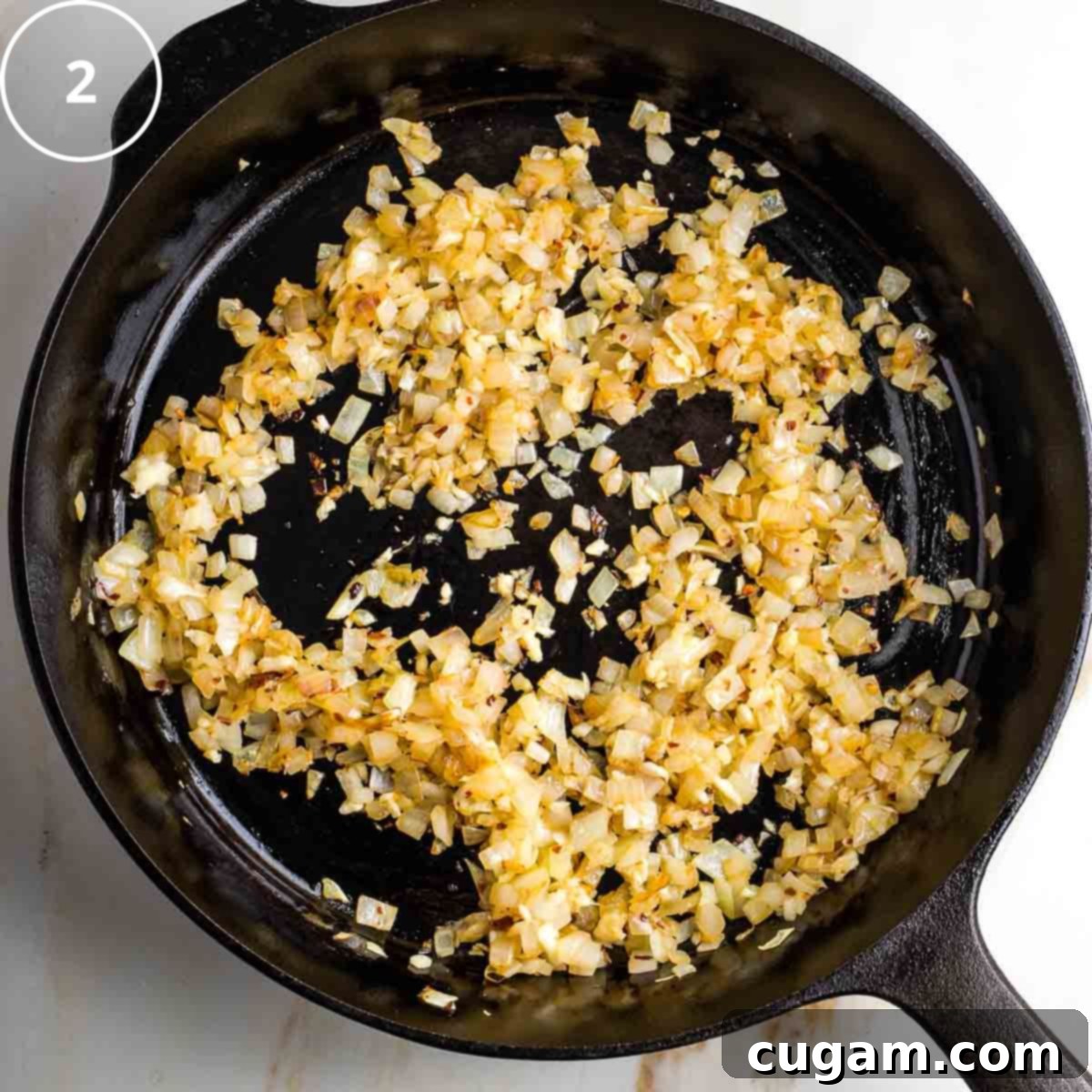Vibrant Mediterranean Cauliflower Rice 5 Step 2: Browned onions in a cast iron skillet.