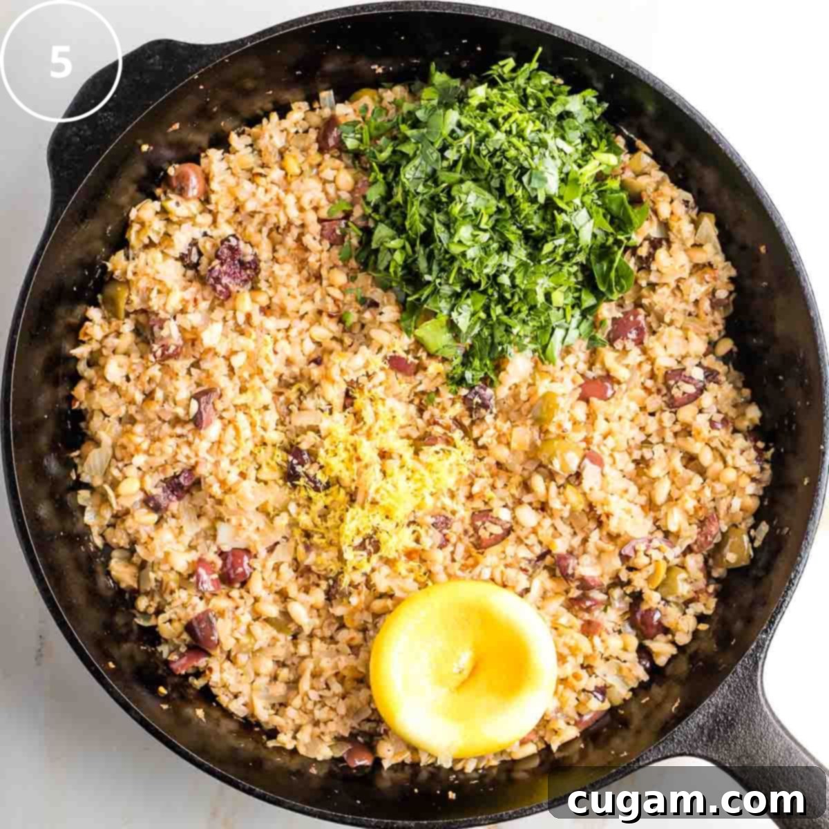 Vibrant Mediterranean Cauliflower Rice 8 Step 5: Finishing touches for Mediterranean cauliflower rice with fresh lemon zest and juice.