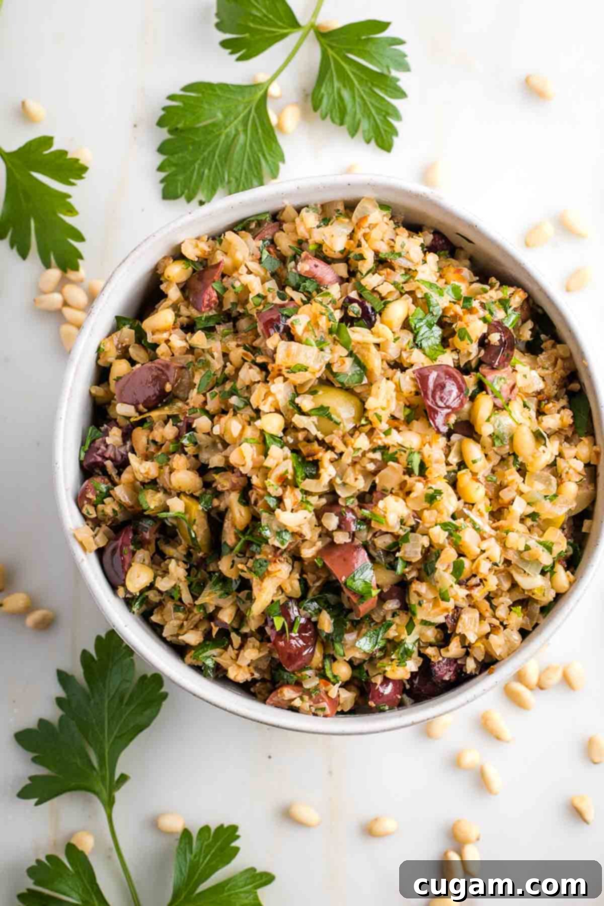 Vibrant Mediterranean Cauliflower Rice 10 Mediterranean cauliflower rice with pine nuts, lemon, fresh herbs and olives.