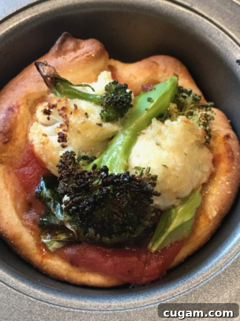 close up of one pizza muffin with vegan ricotta and roasted broccoli