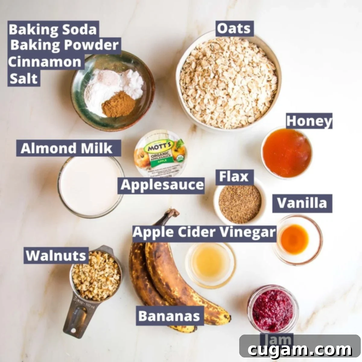 A vibrant flat lay showcasing all the essential ingredients for Jam Muffins: oats, honey, ground flaxseed, vanilla extract, apple cider vinegar, your favorite jam, ripe bananas, chopped walnuts, almond milk, unsweetened applesauce, baking soda, baking powder, cinnamon, and a pinch of salt.