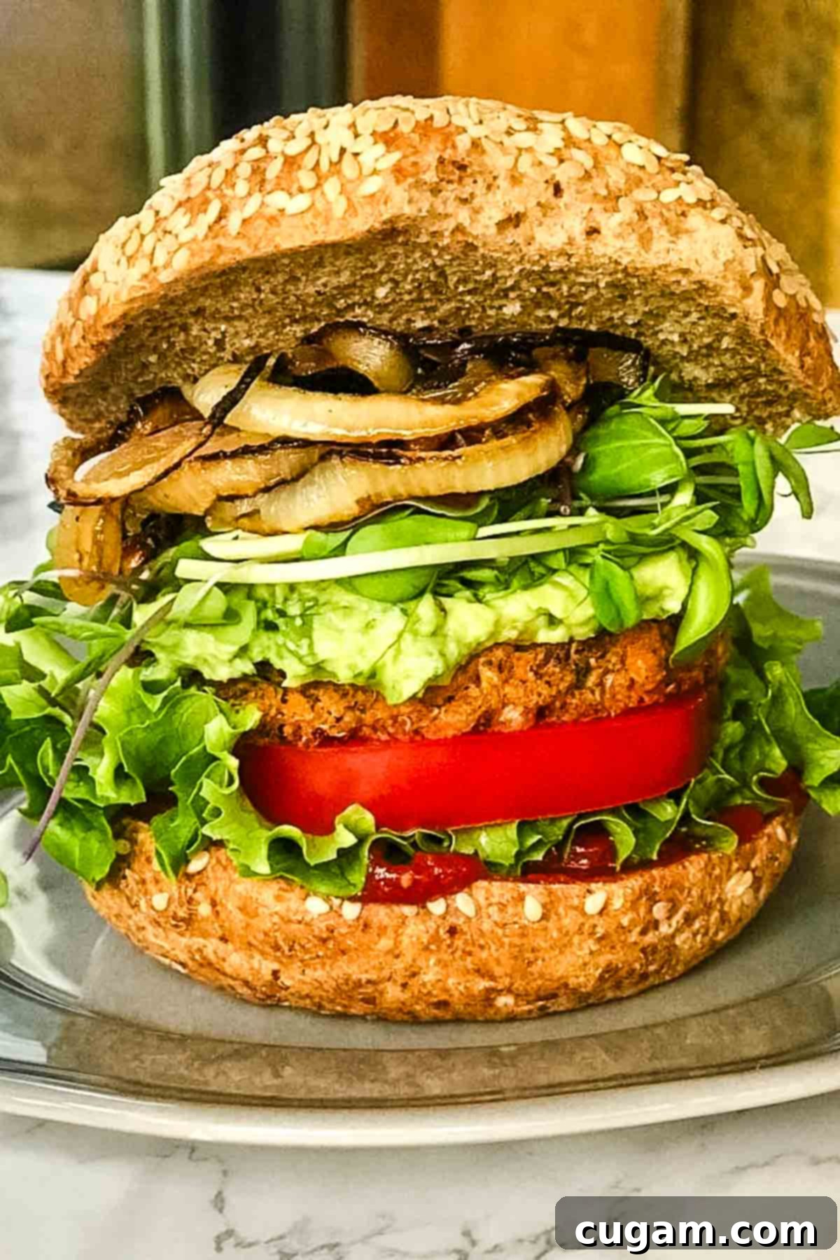 Loaded veggie burger with grilled onions, guacamole, lettuce, tomato and ketchup. 