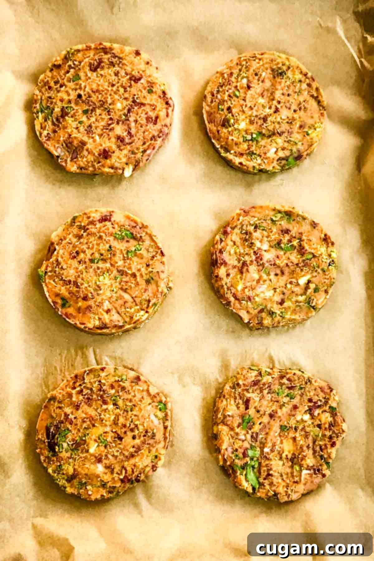 6 veggie burger patties on a parchment lined baking tray.