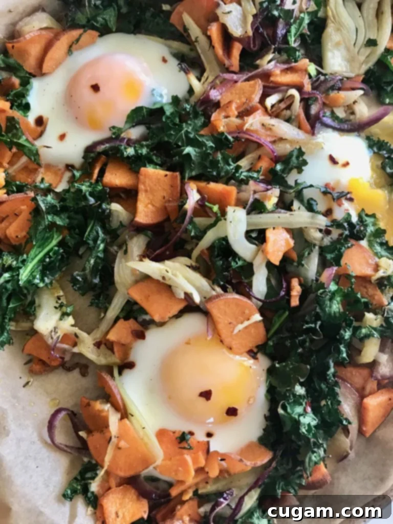 Perfectly cooked eggs on top of kale, sweet potatoes and onions. 
