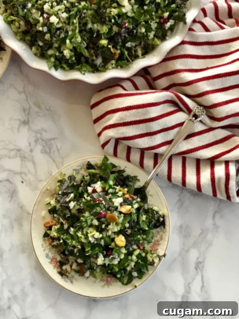 Bowl of greens with pomegranate seeds and nuts. 