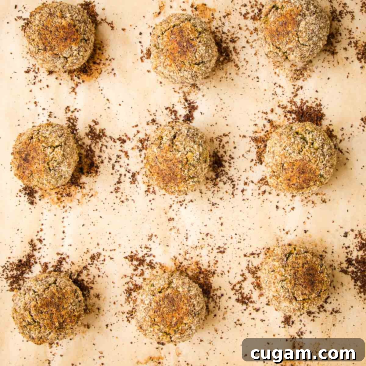 close up of 9 baked falafel balls on a baking tray.
