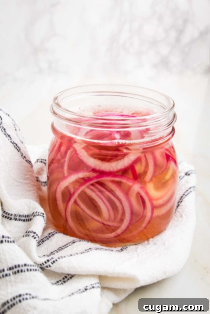 Pickled red onions in a jar.