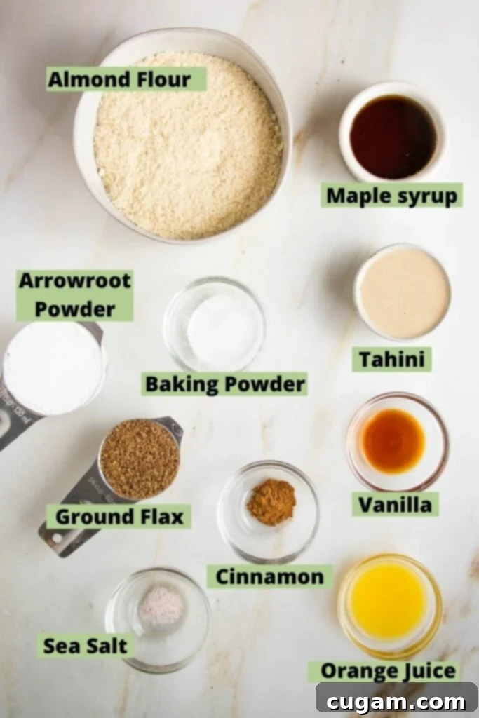 labeled ingredients for easy hamentaschen recipe: almond flour, arrowroot powder, baking powder, ground flax, cinnamon, sea salt, maple syrup, tahini, vanilla, and orange juice.