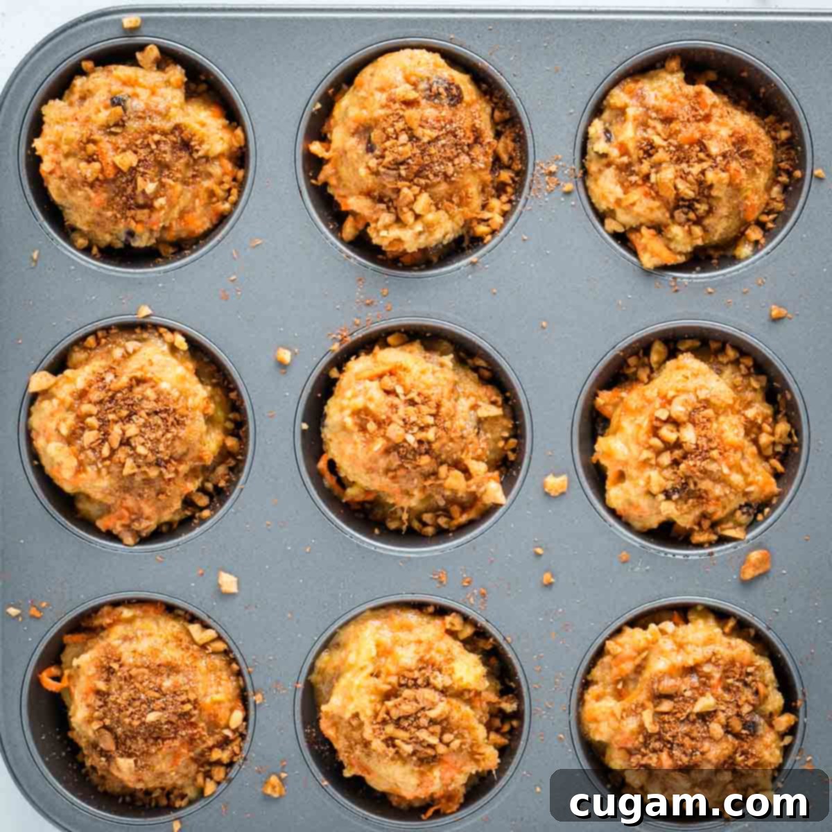Sprinkling walnut and cinnamon mixture over muffin batter.