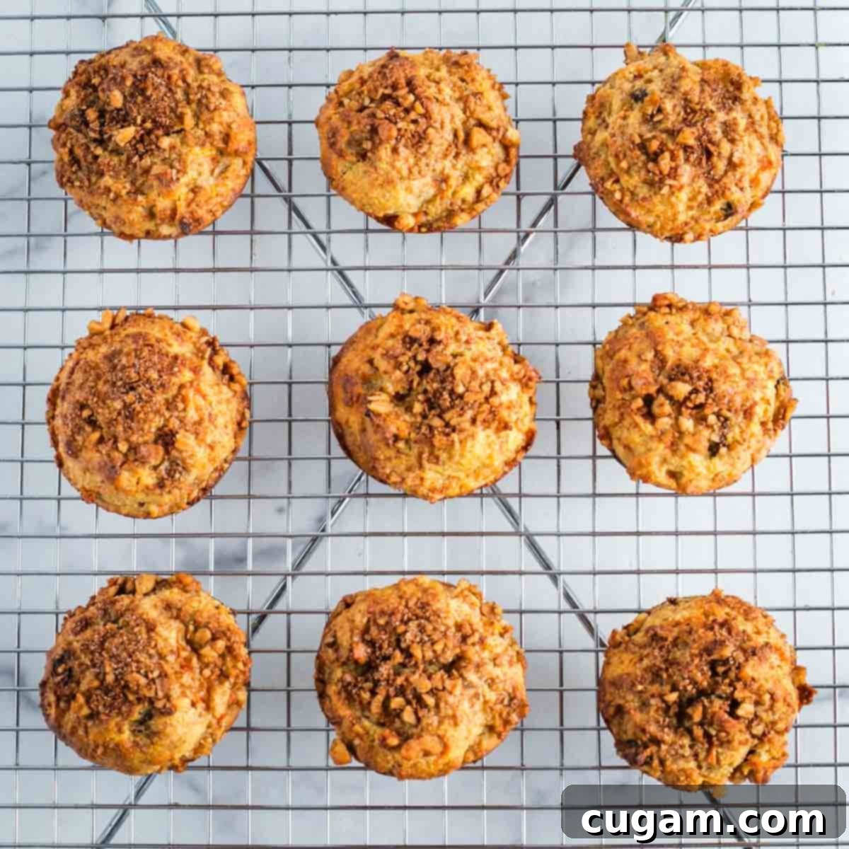 Carrot muffins cooling on a wire rack.