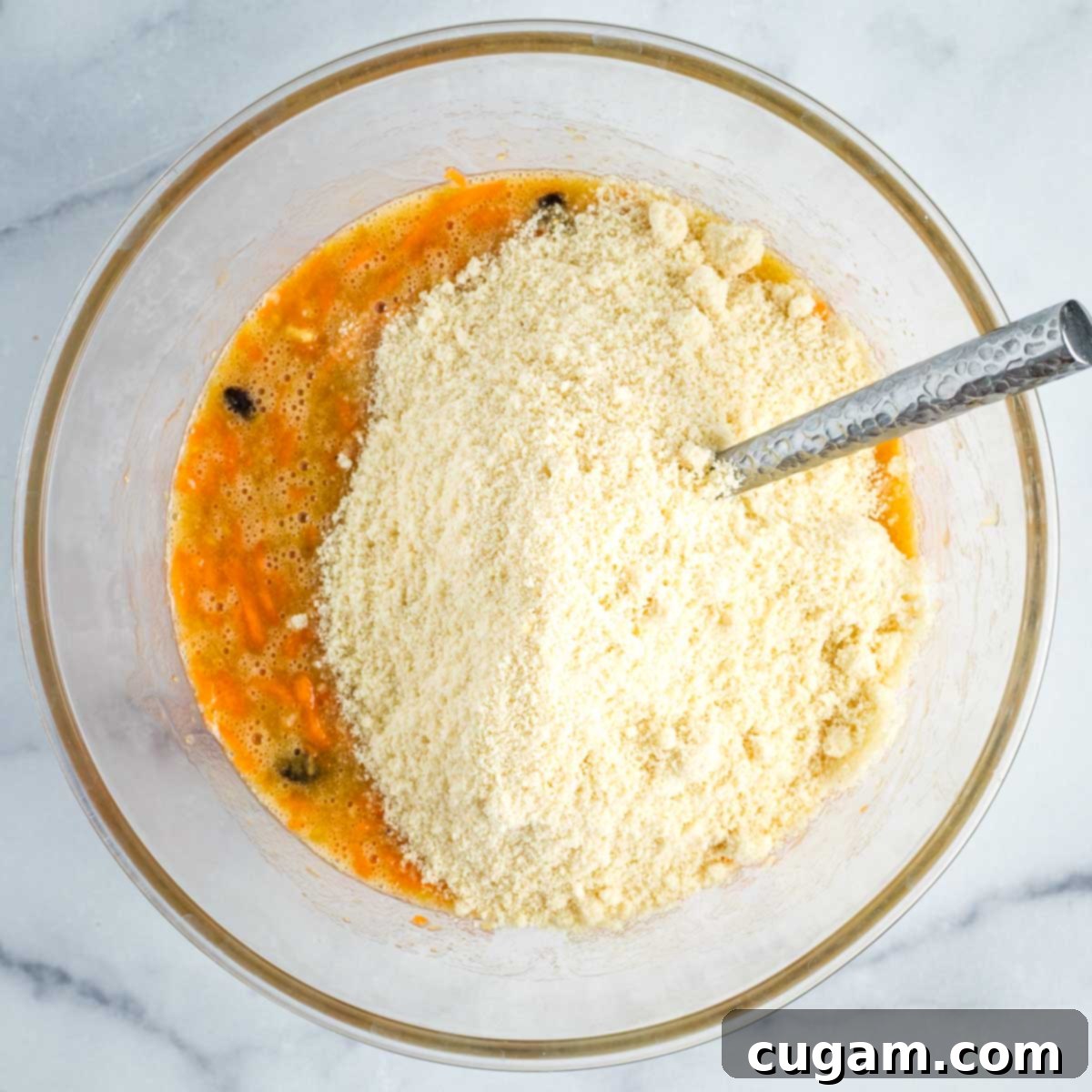 Stirring almond flour into the muffin batter.