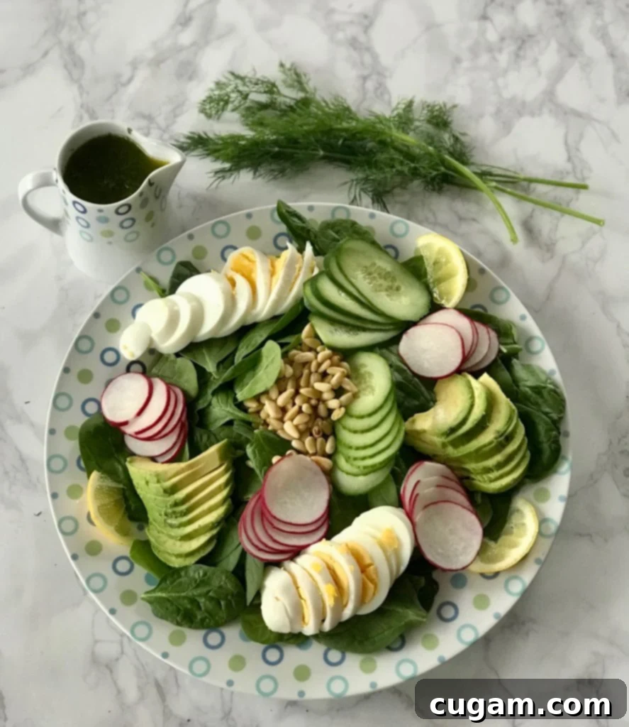Quick & Easy Spinach Salad 2 Sliced boiled eggs, avocado, cucumbers, and pine nuts on a bed of spinach