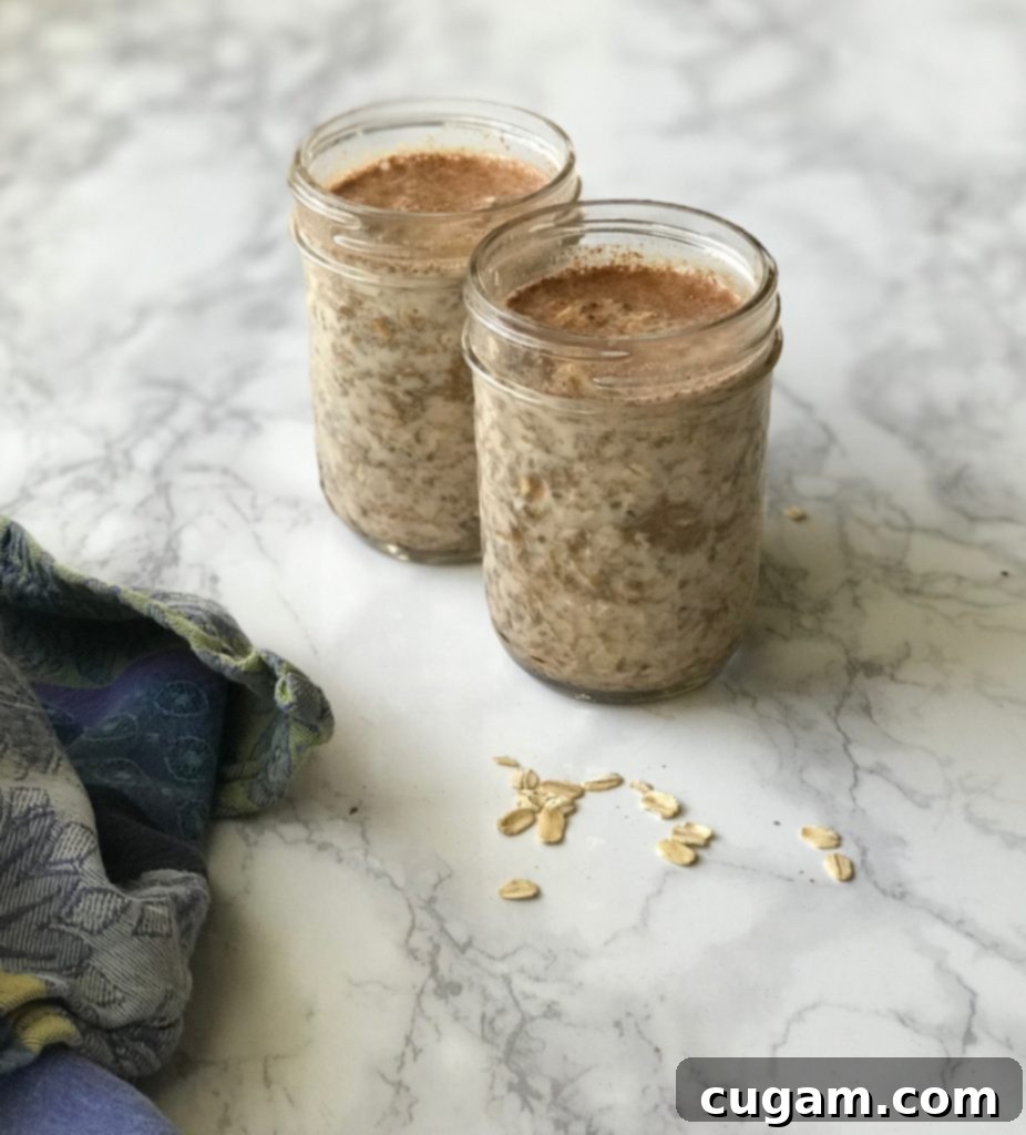Jars of Gingerbread Overnight Oats in the fridge, ready to be enjoyed.