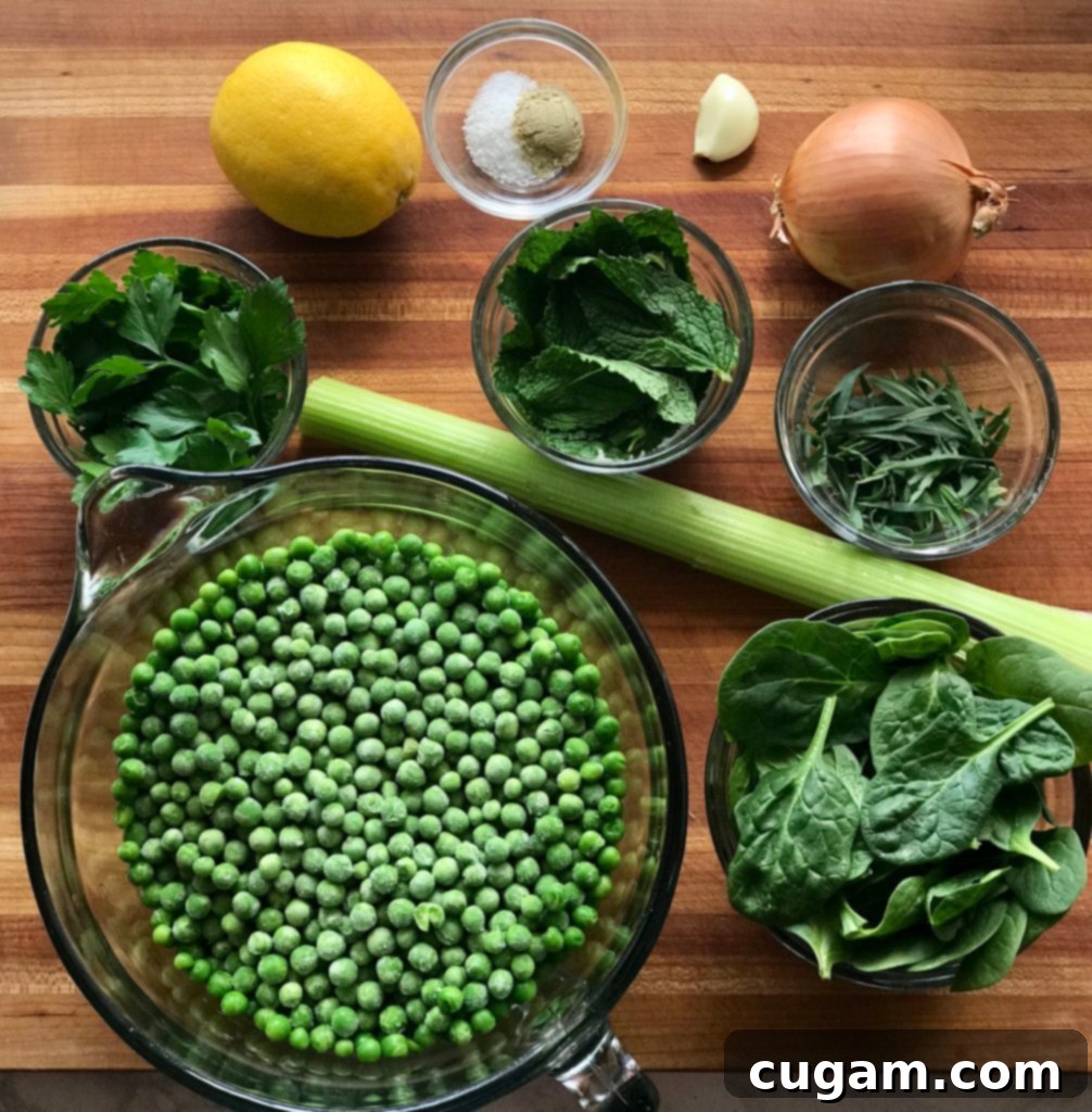 Fresh herbs, peas, lemon, and celery laid out on a cutting board, ready for Spring Greens Soup.