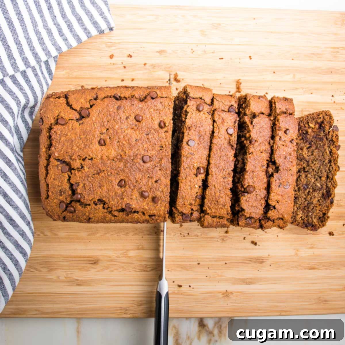 Loaf of chocolate chip banana bread cut into thick slices.