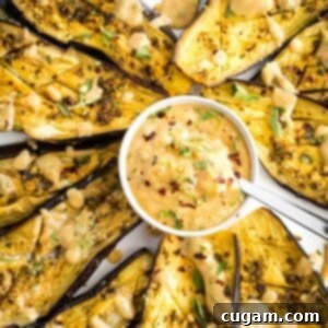 Roasted eggplant with fresh herbs and a tahini sauce.