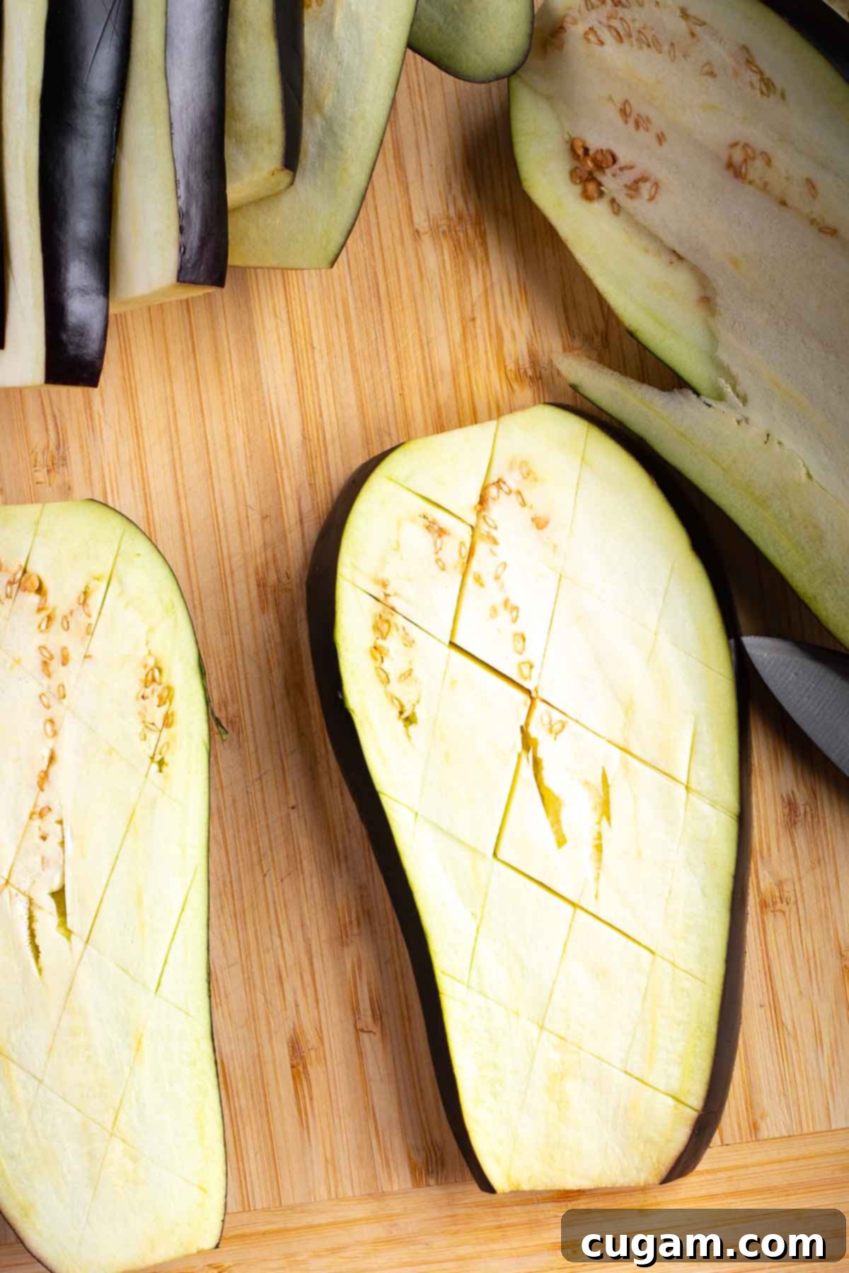 Up close slice of eggplant that's been diagonally cross cut, not all the way through.
