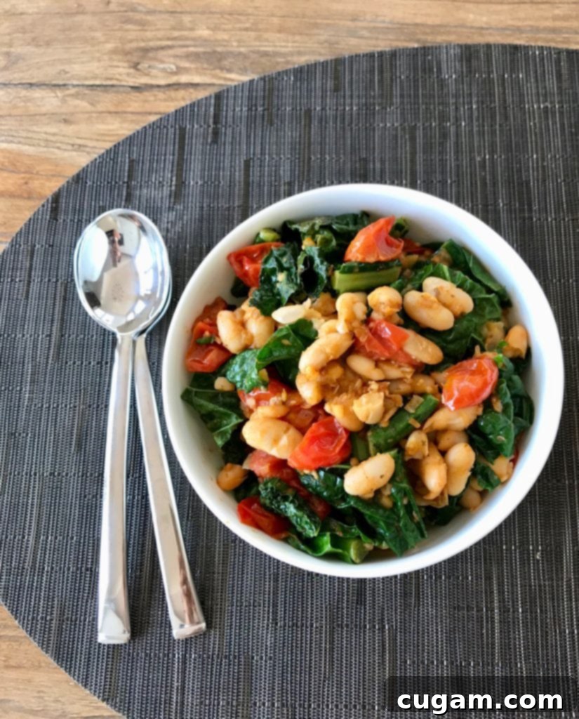 Beans + Greens, Seasonal greens wilted on top of tasty beans and sauteed tomatoes.