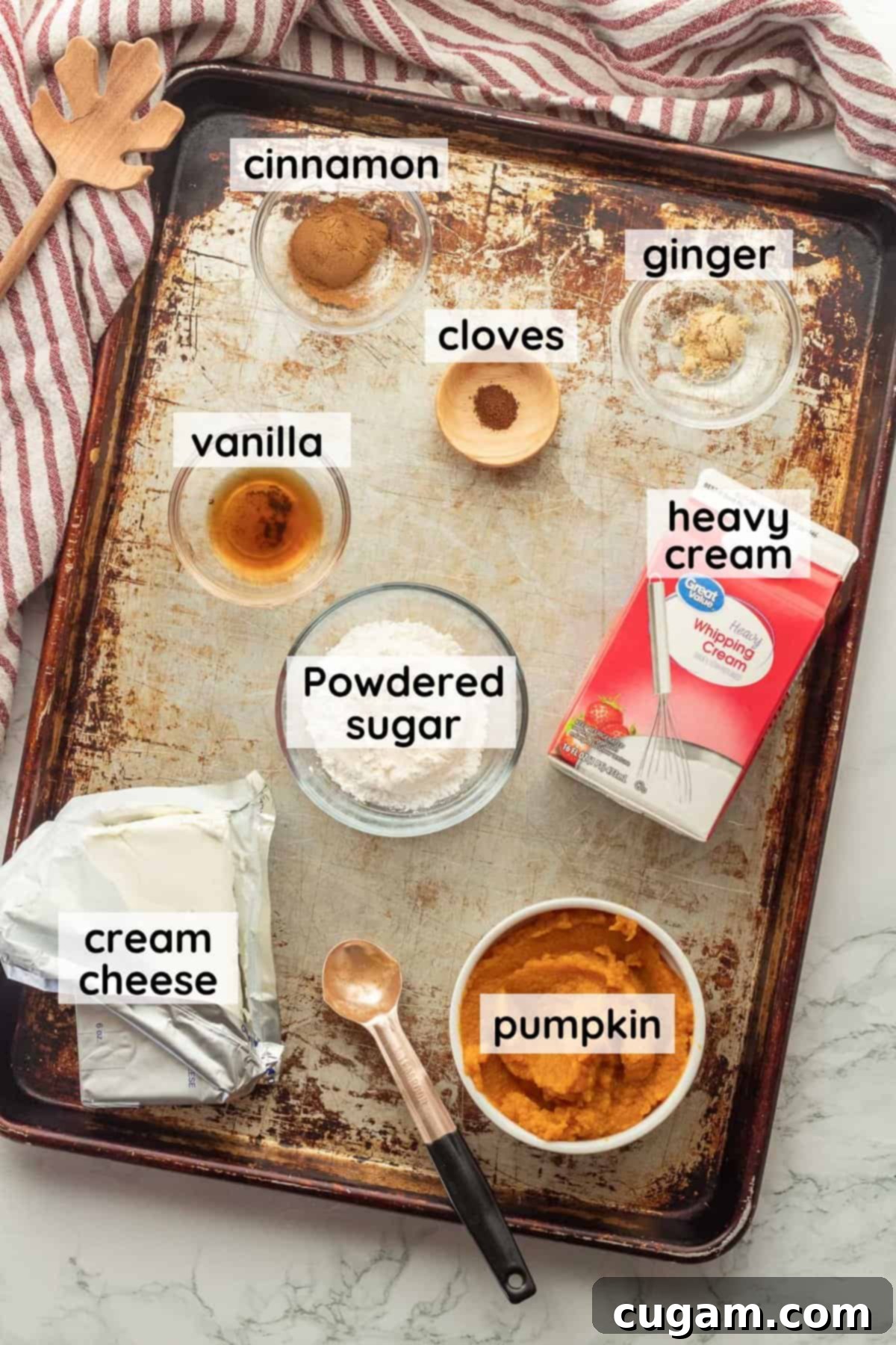 Irresistible Pumpkin Cream Cheese Dip 3 All the essential ingredients for pumpkin cream cheese dip, meticulously labeled and arranged in clear glass bowls on a sleek metal tray, ready for preparation.