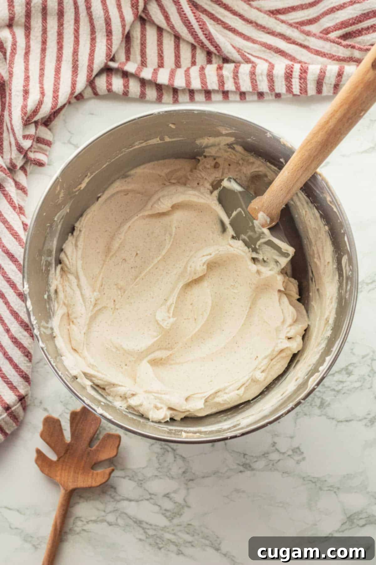 Irresistible Pumpkin Cream Cheese Dip 7 The perfectly whipped, fluffy cream cheese and spice mixture, awaiting the final touch of pumpkin puree, showcased in a shiny metal mixing bowl with a rubber spatula.