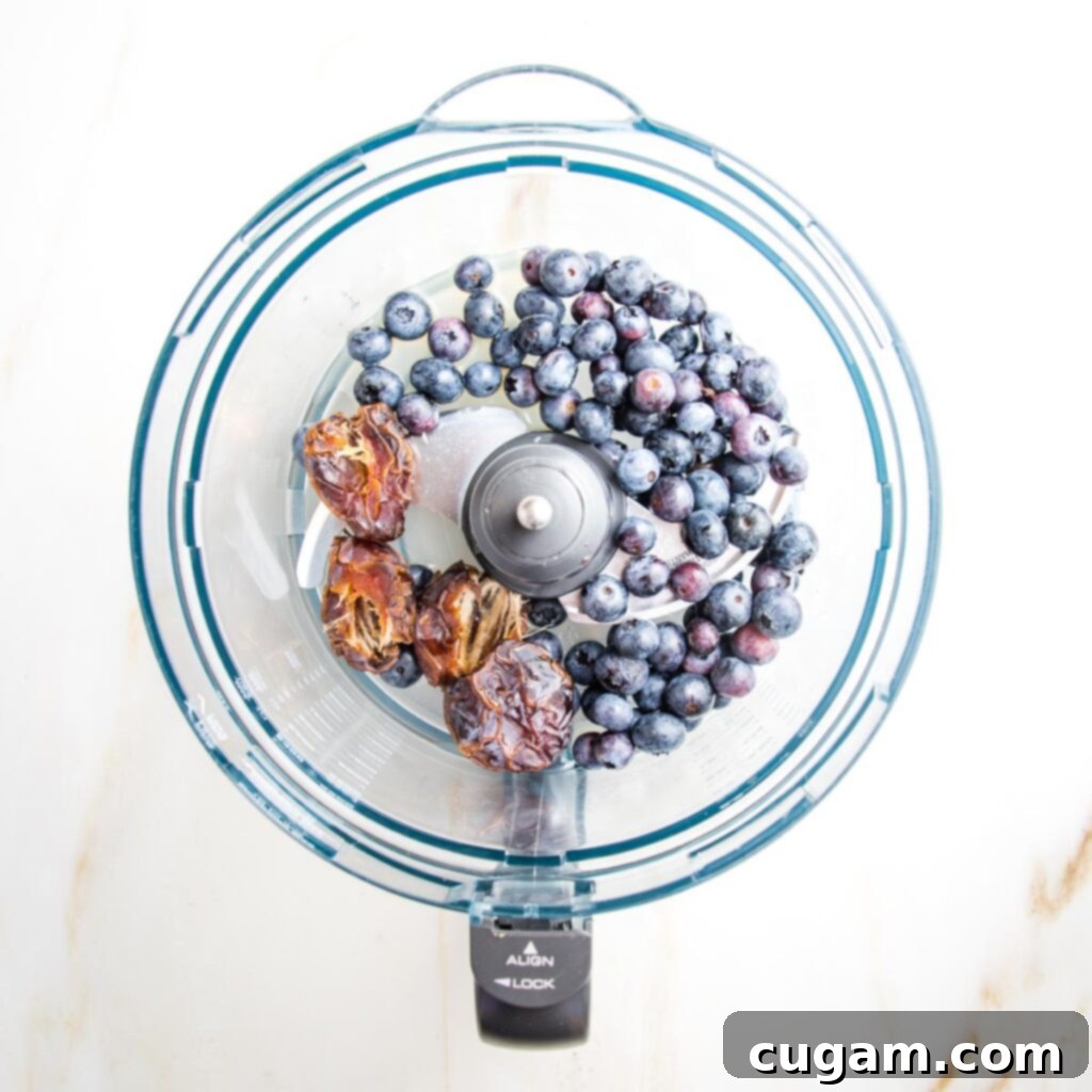 blueberries, dates and lemon juice in a food processor bowl, before blending.