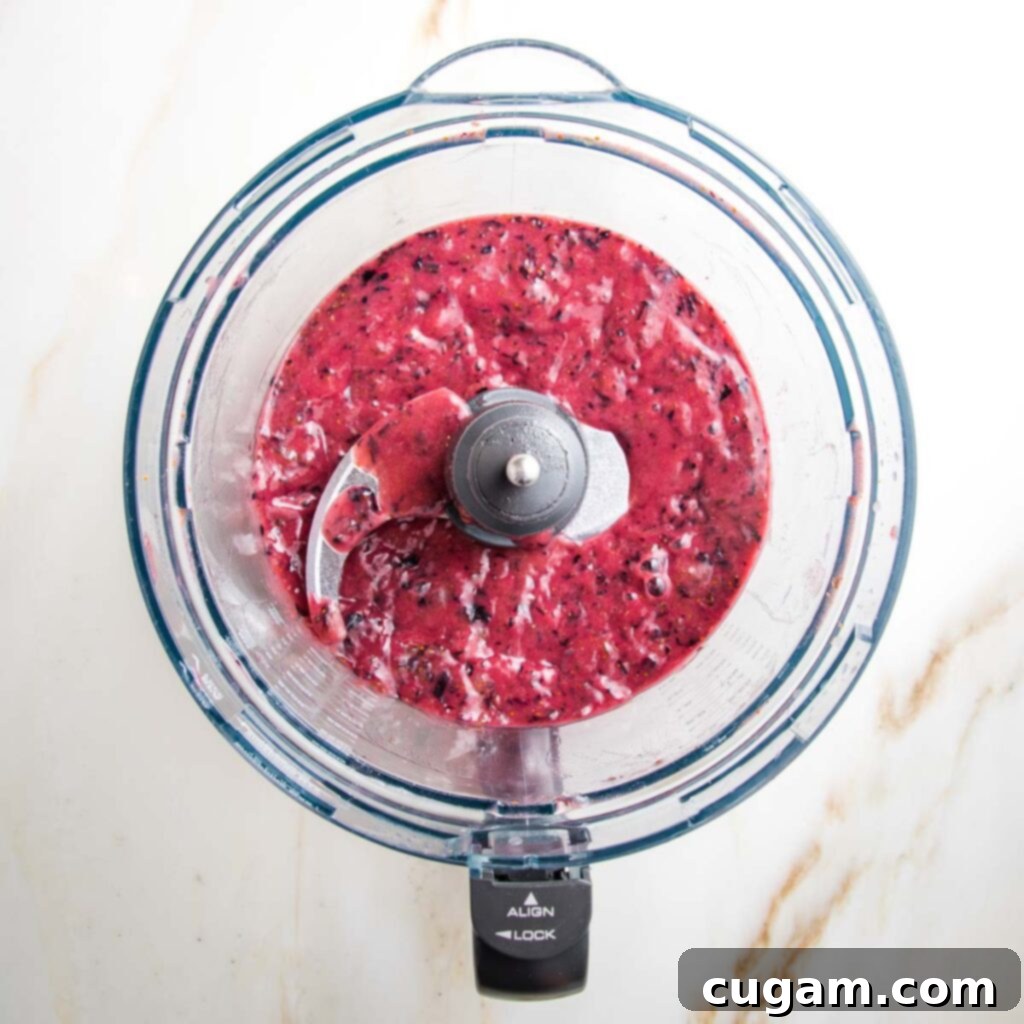 blueberry puree inside a food processor bowl, after blending.