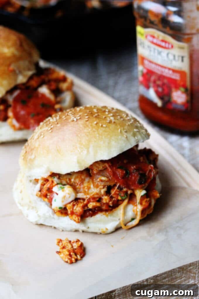A close-up of the finished Skillet Pepperoni Pizza Sloppy Joes, garnished with fresh pepperoni and herbs, ready for serving. #Ad #ReachforRustic