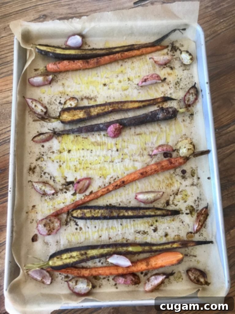 Roasted root vegetables seasoned with cumin, presented on a rustic wooden board, ready to be enjoyed.