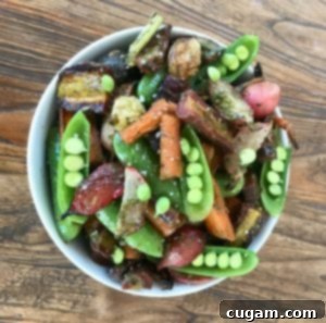 Snap peas, carrots, radishes in a white bowl, ready for a fresh and healthy meal.