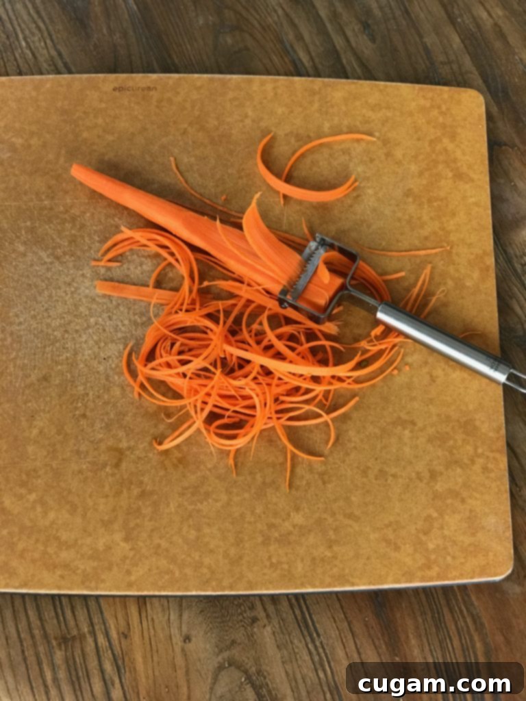 Sesame Soba Noodle and Vegetable Salad 4 Carrot with julienne peeler, making strips