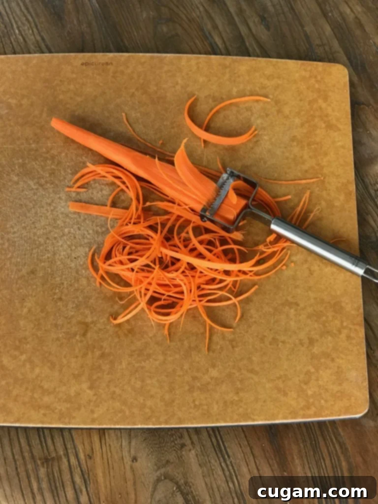 Carrot with julienne peeler, making strips