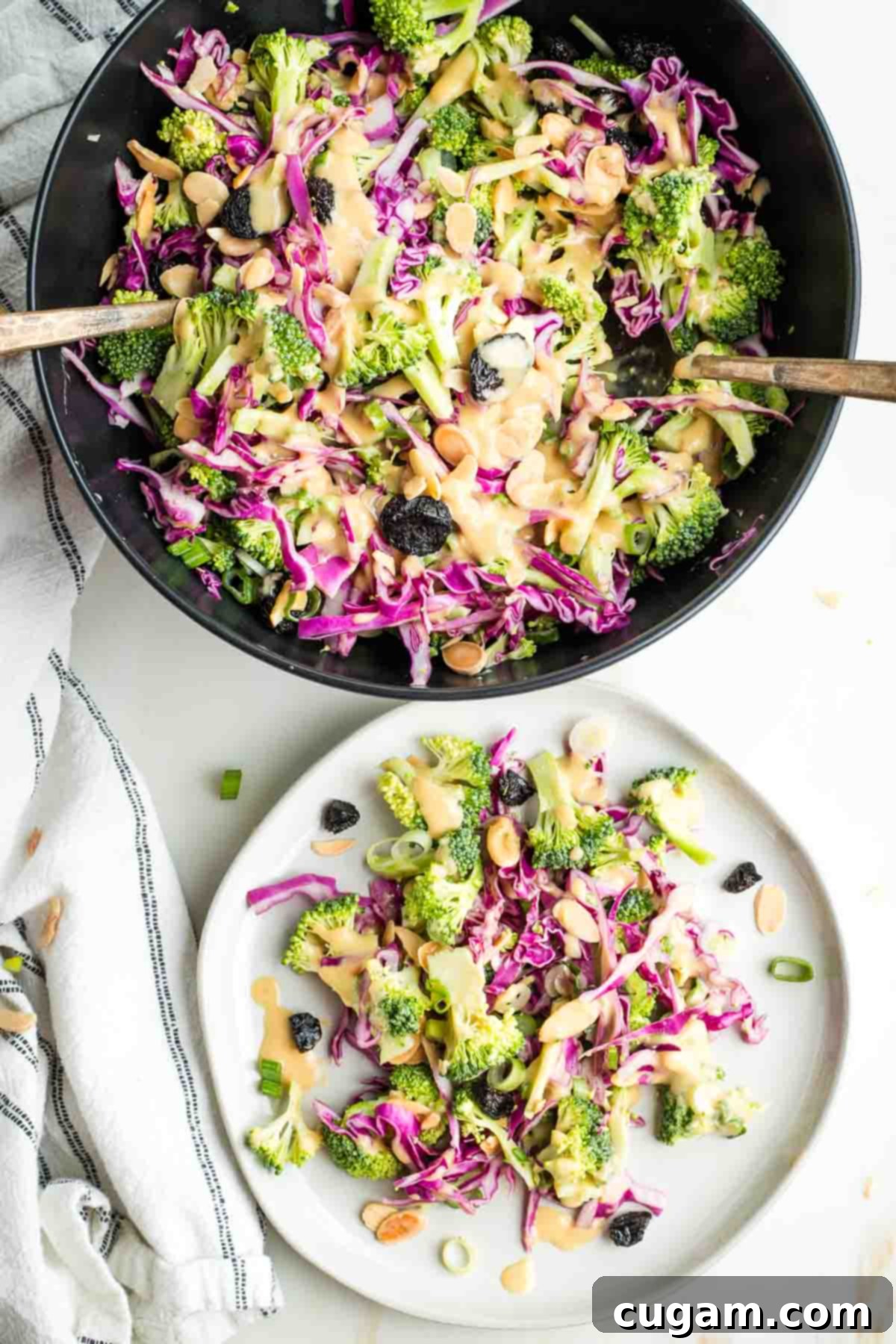 Crisp Raw Broccoli Salad with Miso Dressing 2 Broccoli salad with cabbage, almonds, scallions and miso dressing in a serving bowl and on a plate.