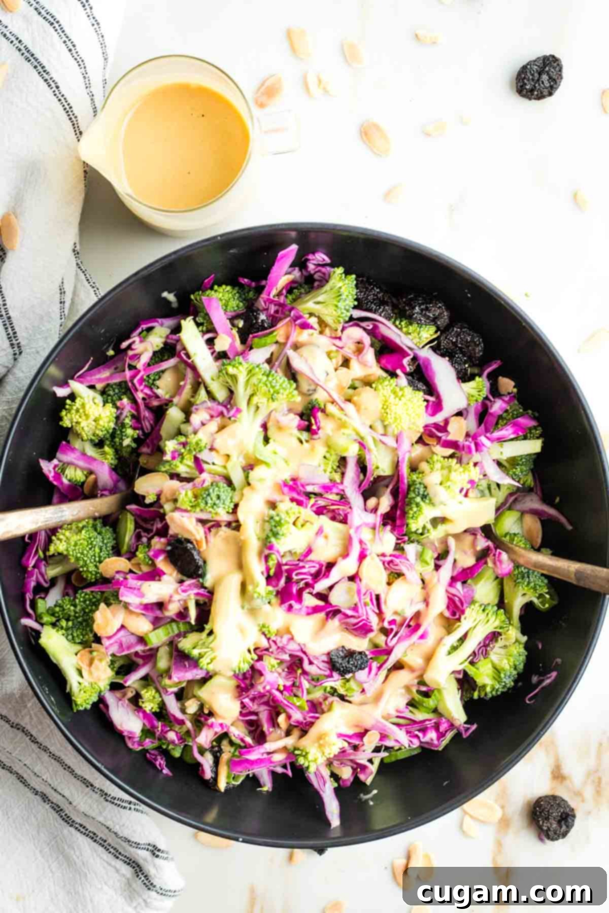 Crisp Raw Broccoli Salad with Miso Dressing 13 Brightly colored broccoli and cabbage with a orangish creamy dressing, sprinkled with almonds and dried cherries.