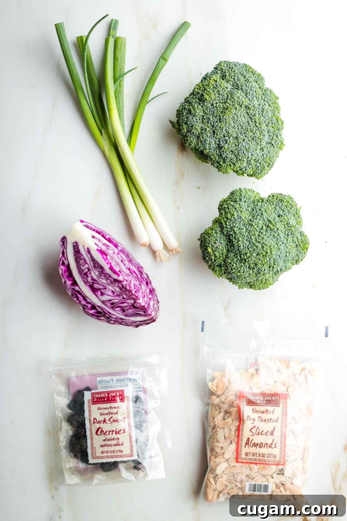 Crisp Raw Broccoli Salad with Miso Dressing 3 Crowns of broccoli, bunch of scallions, quarter head cabbage, package of dried cherries and sliced almonds.