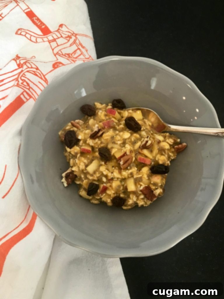 Autumn Spiced Overnight Oats 2 Creamy Pumpkin Overnight Oats topped with seeds and spices, ready to eat for a fall breakfast.