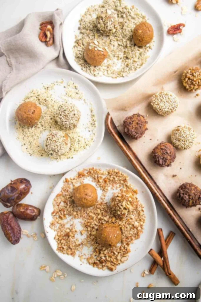 White plates with pumpkin balls rolled around in crushed nuts to coat. There's a tray on the side, lined with parchment with an assortment of finished pumpkin spice balls with toppings.