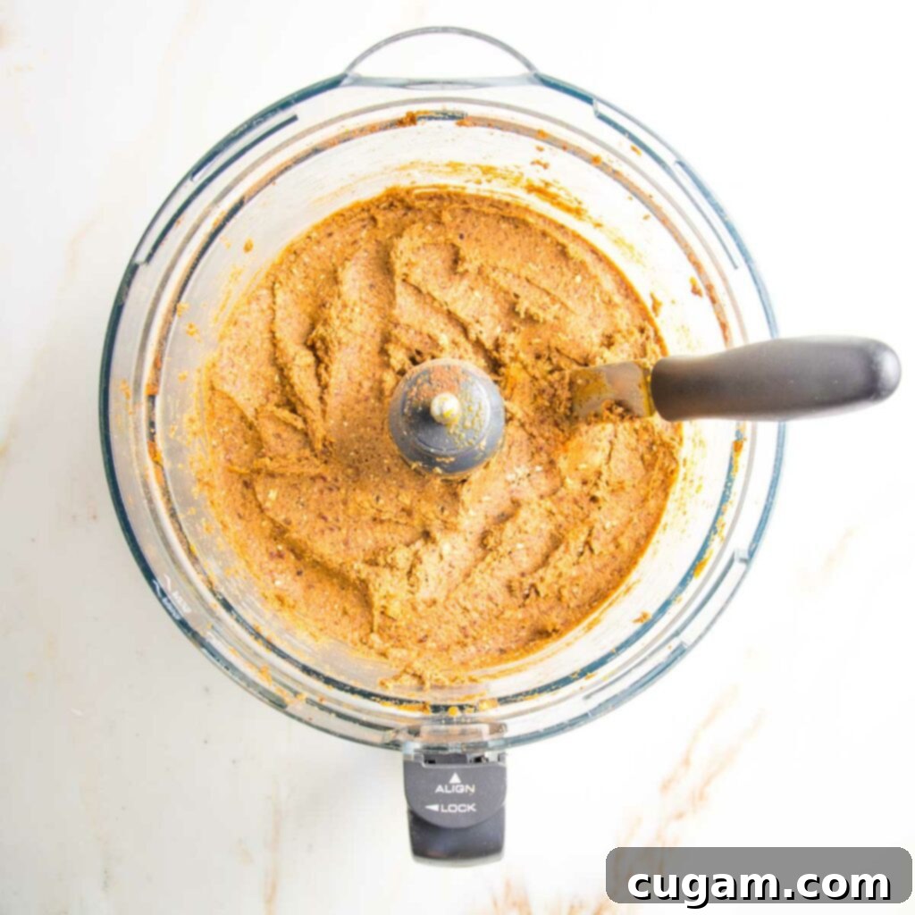 Food processor bowl with pumpkin mixture after being processed.