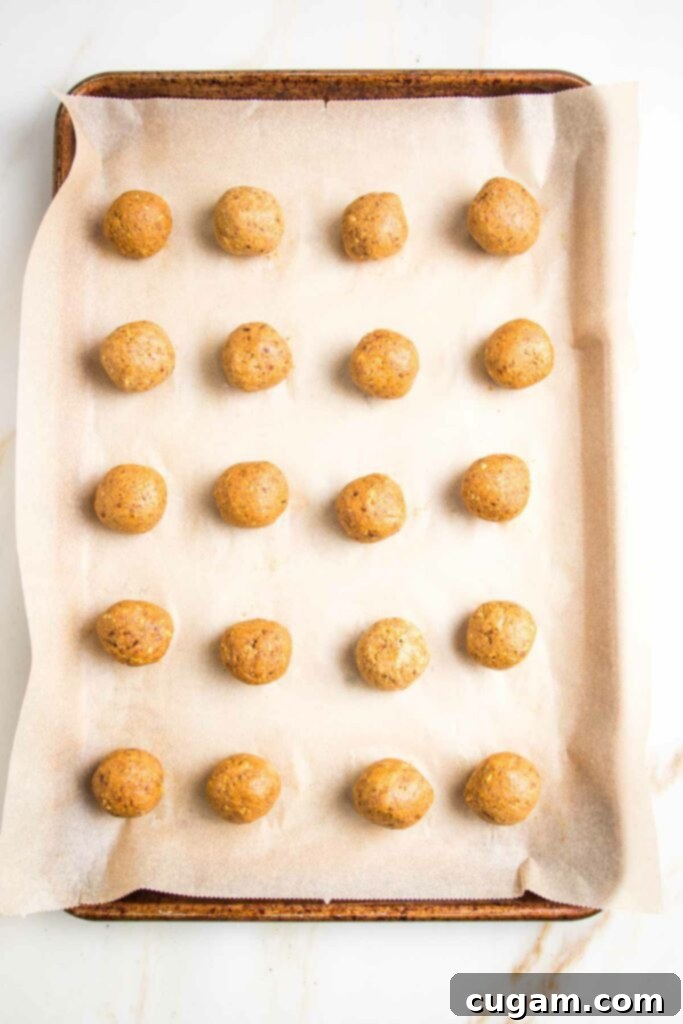 Wetting hands before rolling dough into balls to prevent sticking.