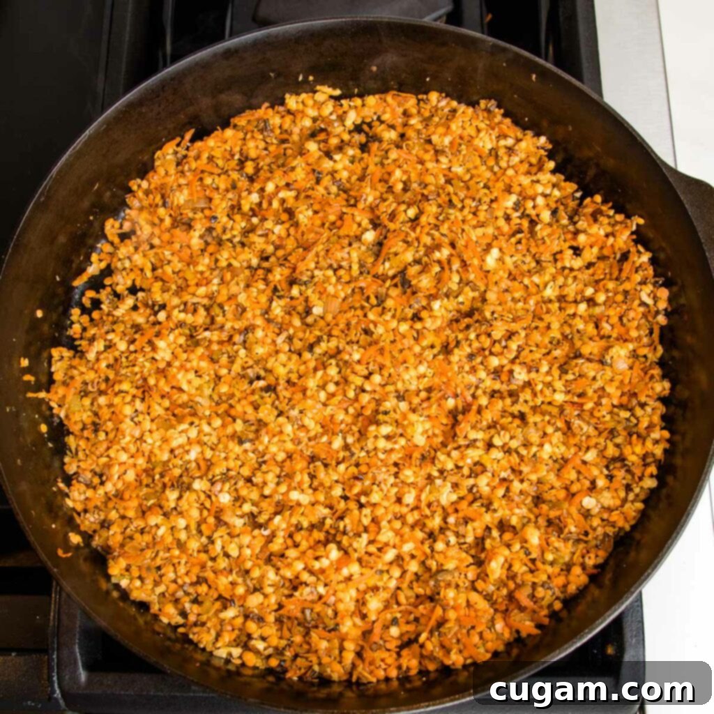 Cast iron skillet with sautéed veggies plus lentils.