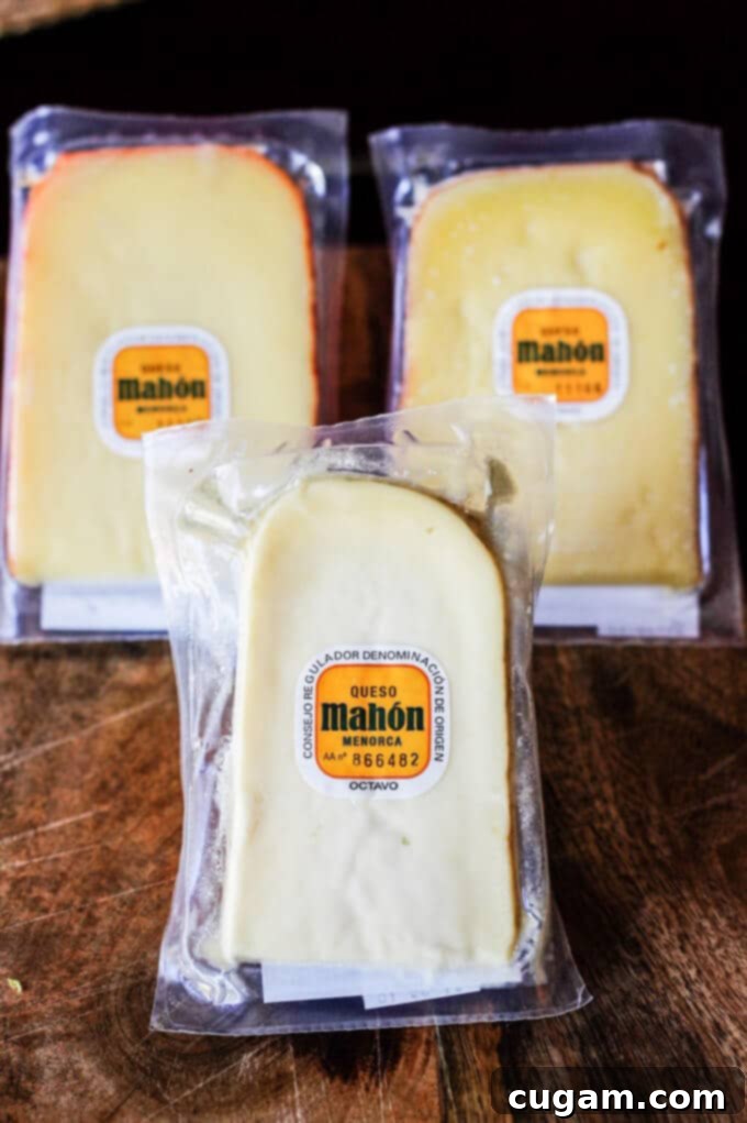 A selection of Mahon-Menorca cheeses, showing different maturities from tender to cured, ready for a cheese board.