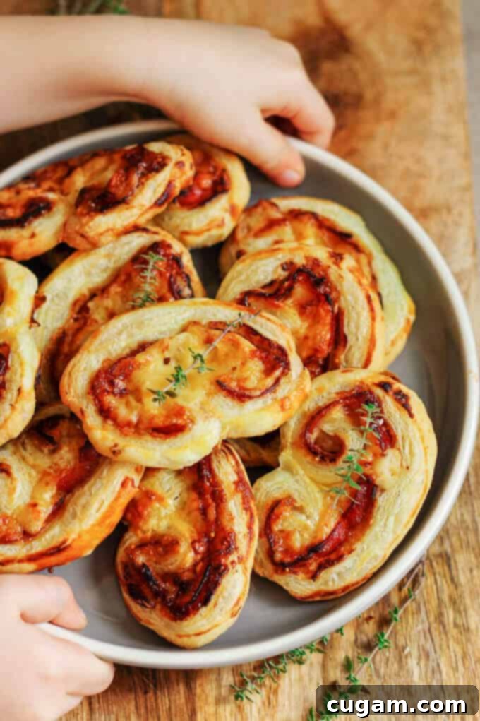 Spreading fig jam evenly over a sheet of puff pastry.