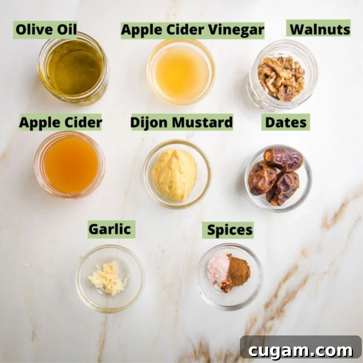 Labeled ingredients for apple vinaigrette: Olive oil, apple cider vinegar, walnuts, apple cider, dijon mustard, dates, garlic, spices.