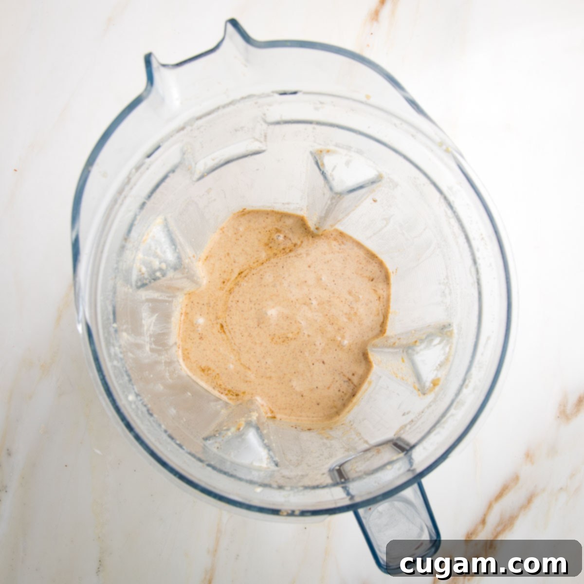 Emulsified apple vinaigrette in the pitcher of a vitamix blender.