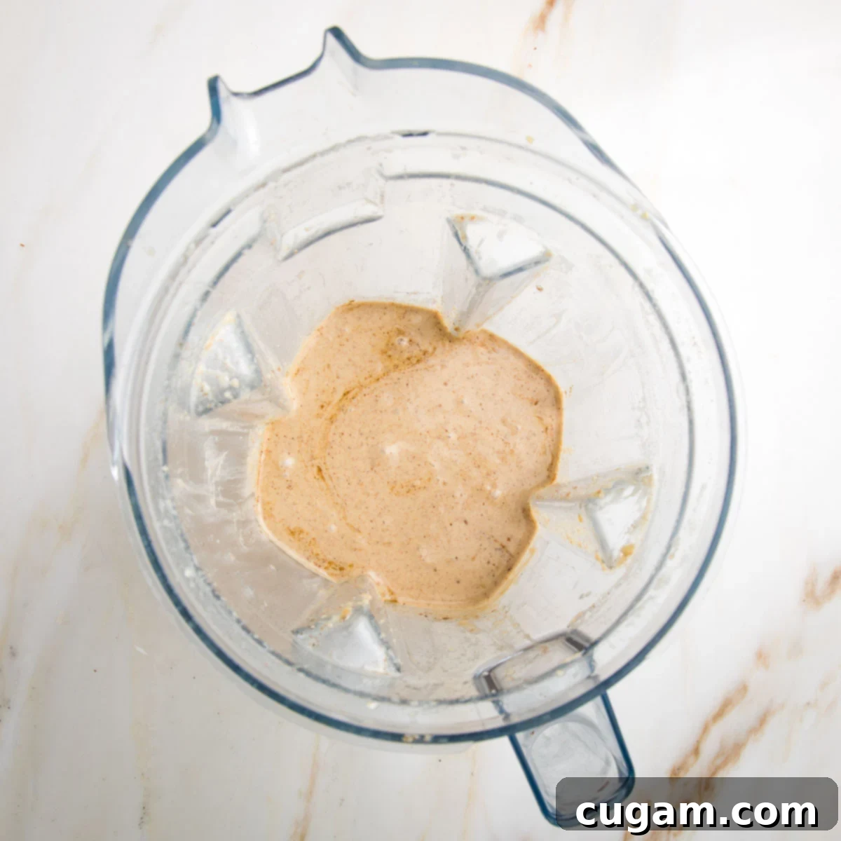 Emulsified apple vinaigrette in the pitcher of a vitamix blender.