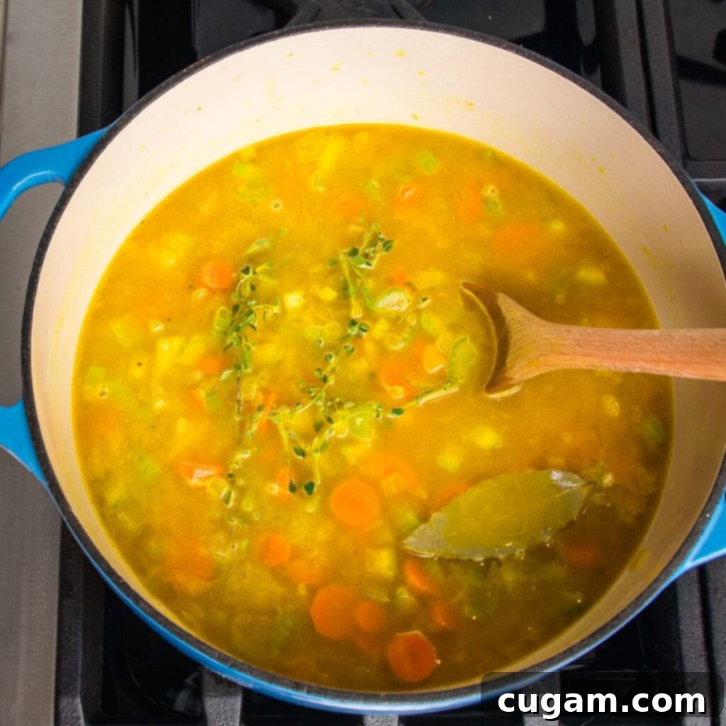 Ingredients being mixed in a Dutch oven.