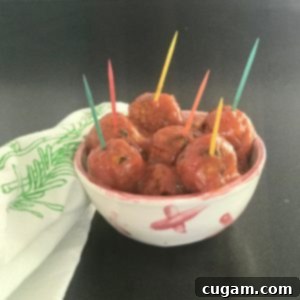 Vegan Sweet and Sour Meatballs in a small dish with colorful toothpics.